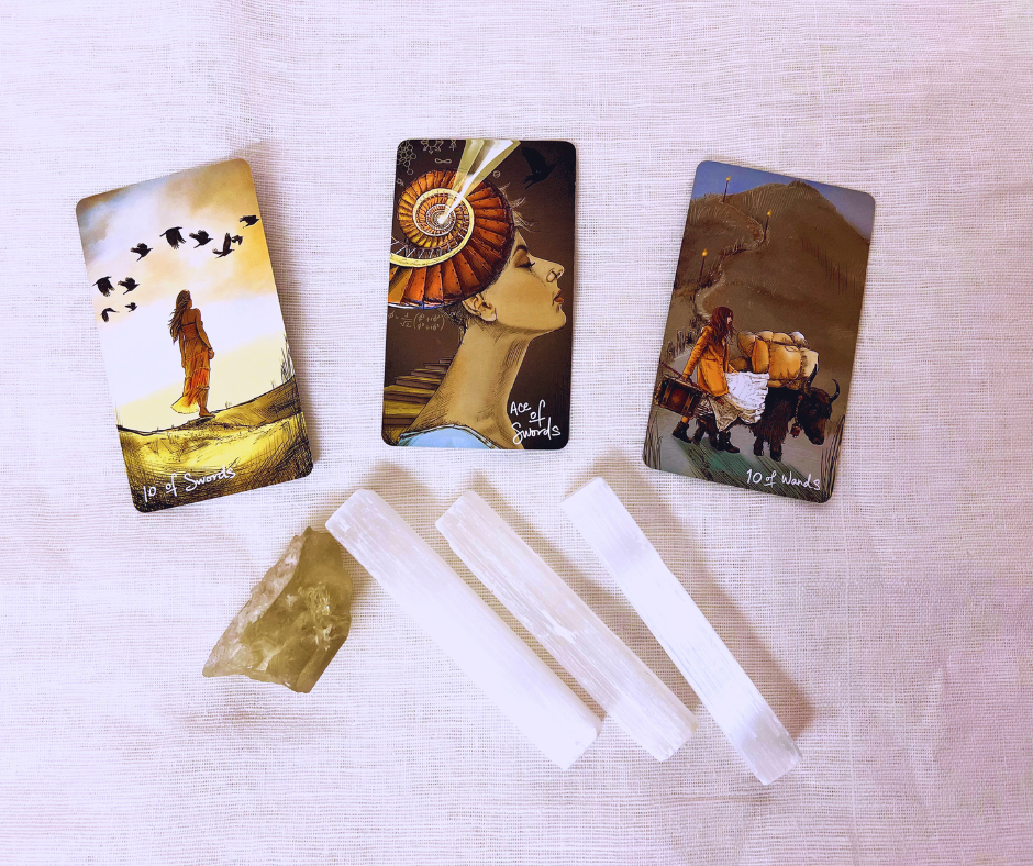 Photo of 3 tarot cards with crystals surrounding