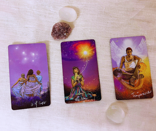 photo of 3 tarot cards with surrounding crystals