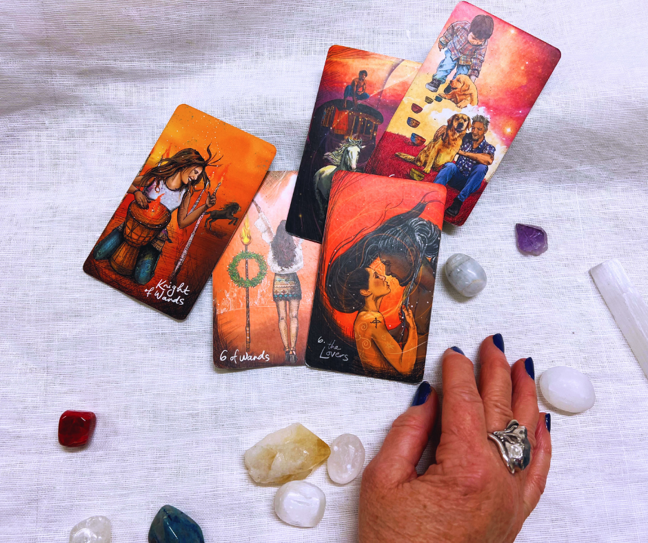 photo of tarot cards surrounded by crystals