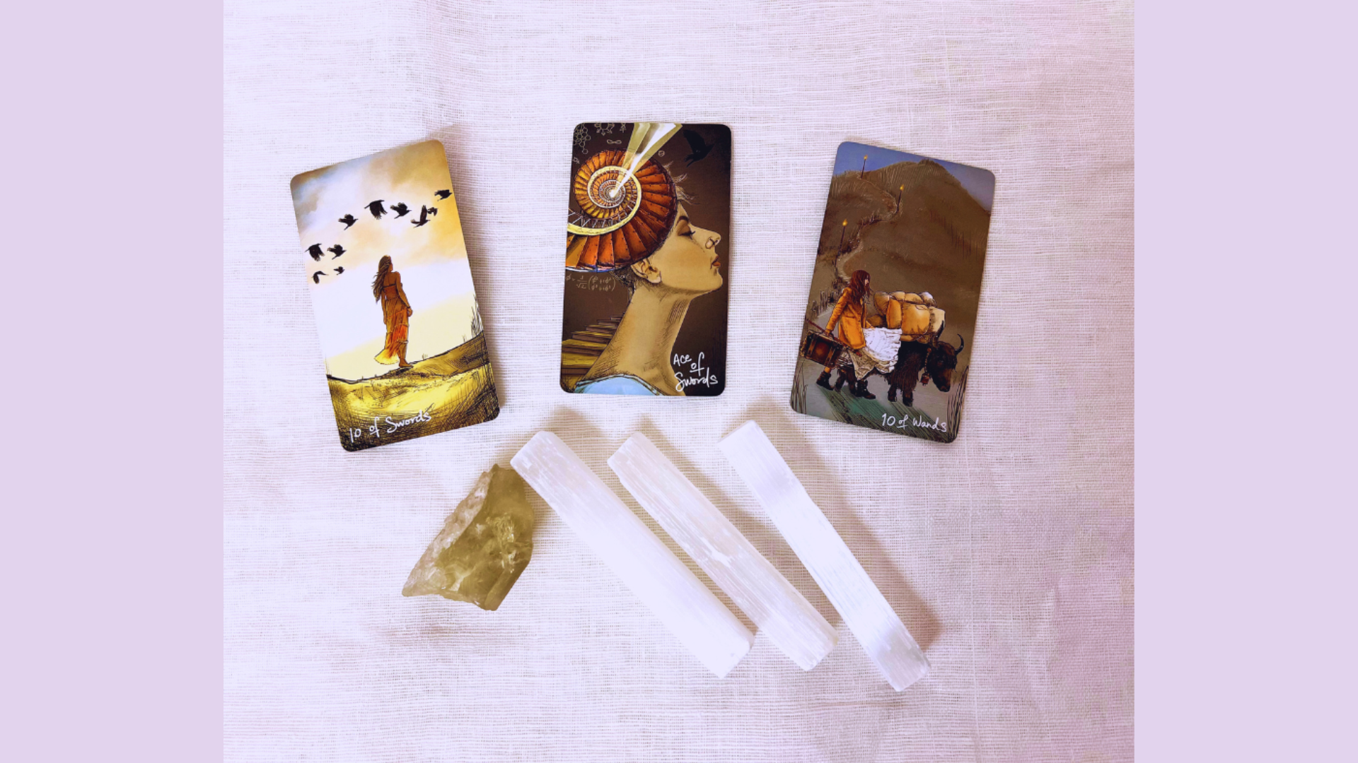 Photo of 3 tarot cards with surrounding crystals